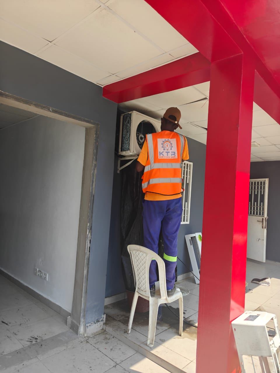 Technician installing air conditioning — indoor wall unit