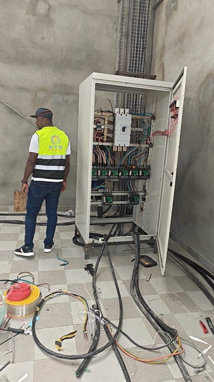 Technician installing an electrical cabinet — interior site