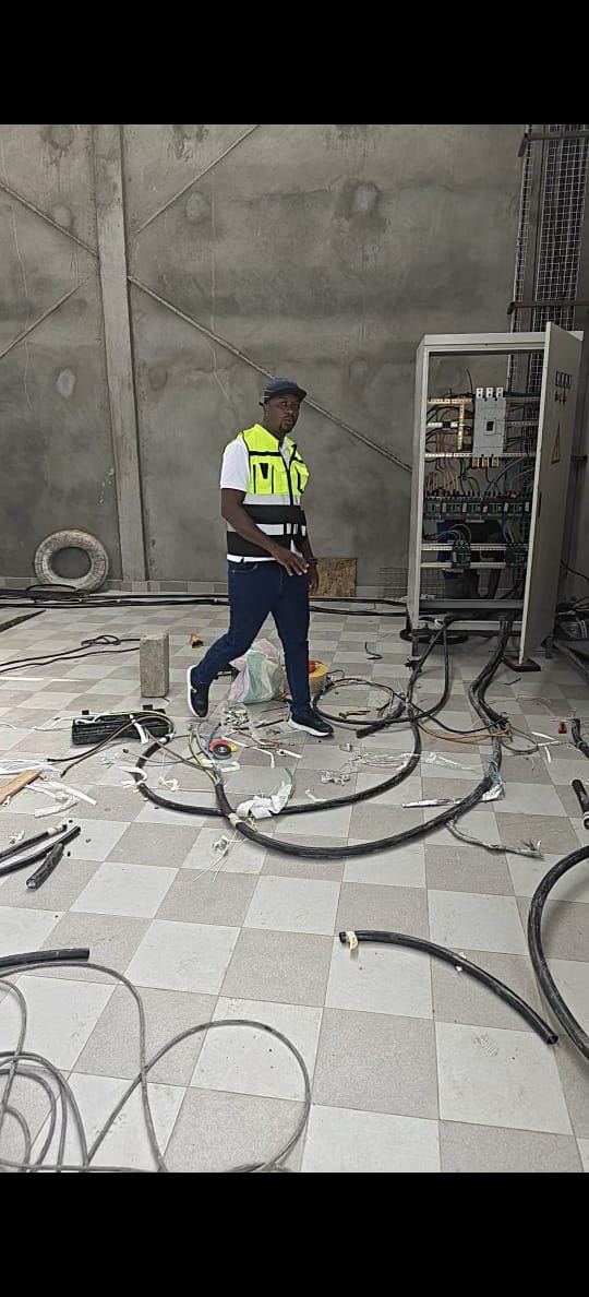 Technician wiring an electrical cabinet — construction site